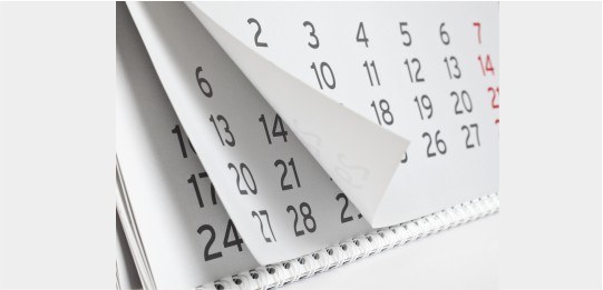 Imagem de um calendário de mesa com páginas de alguns meses